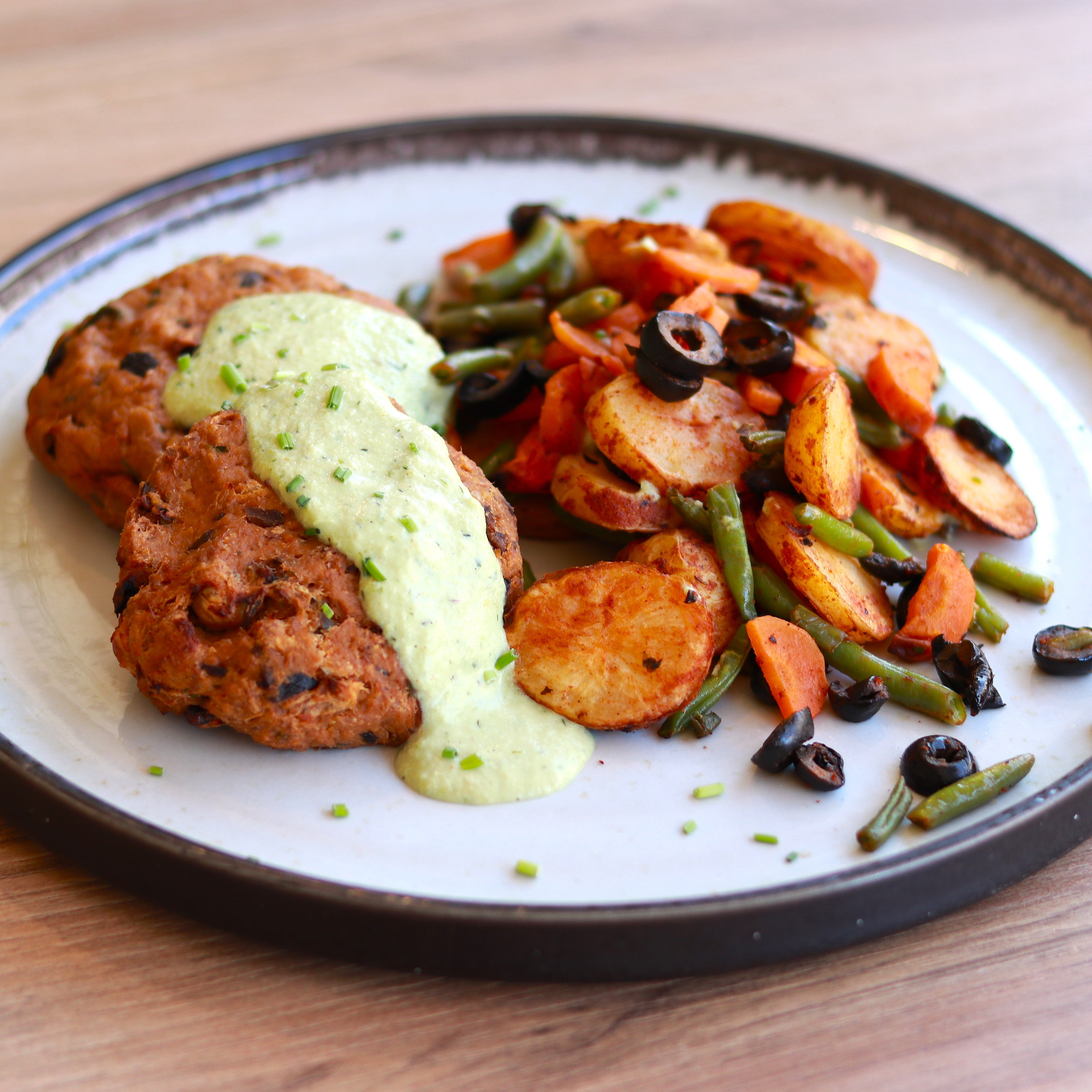 Tuna and olive burger with charred lemon and herb sauce