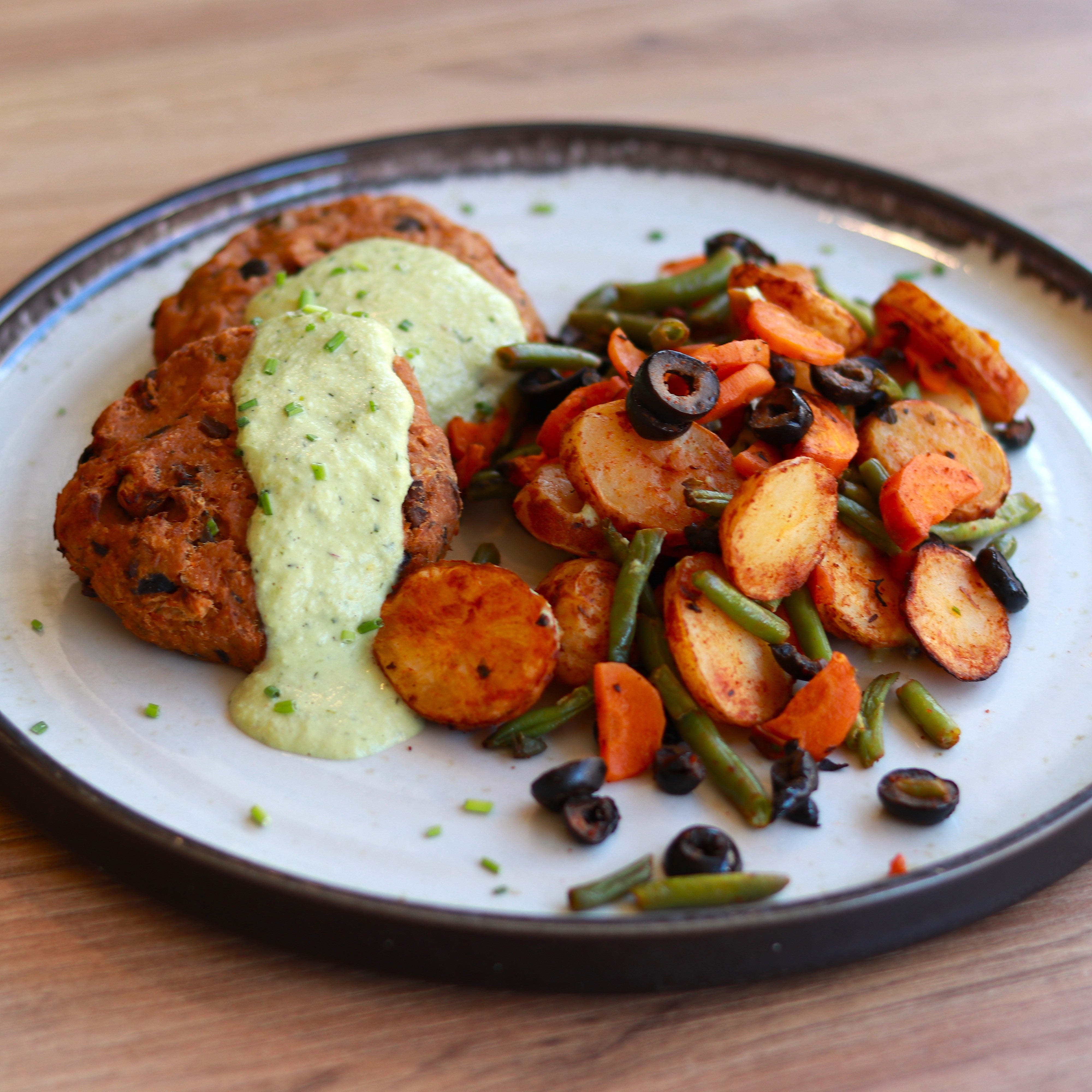 Tuna and olive burger with charred lemon and herb sauce
